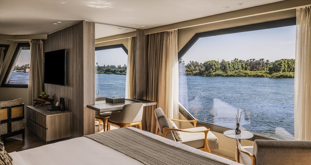 The Royal Suite opens directly to the Nile — floor-to-ceiling windows, nowhere else to look