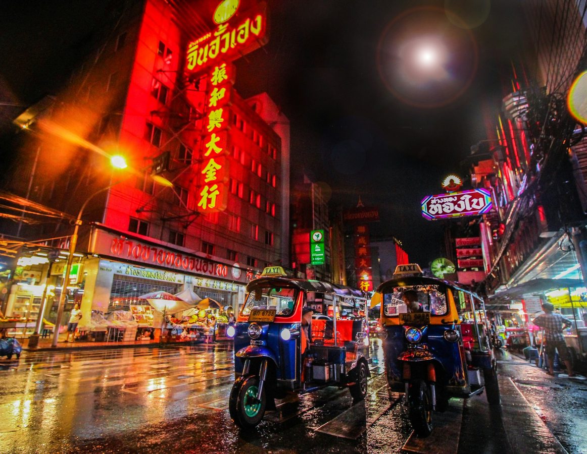Bangkok at night with tuk tuks and bright lights, Thailand