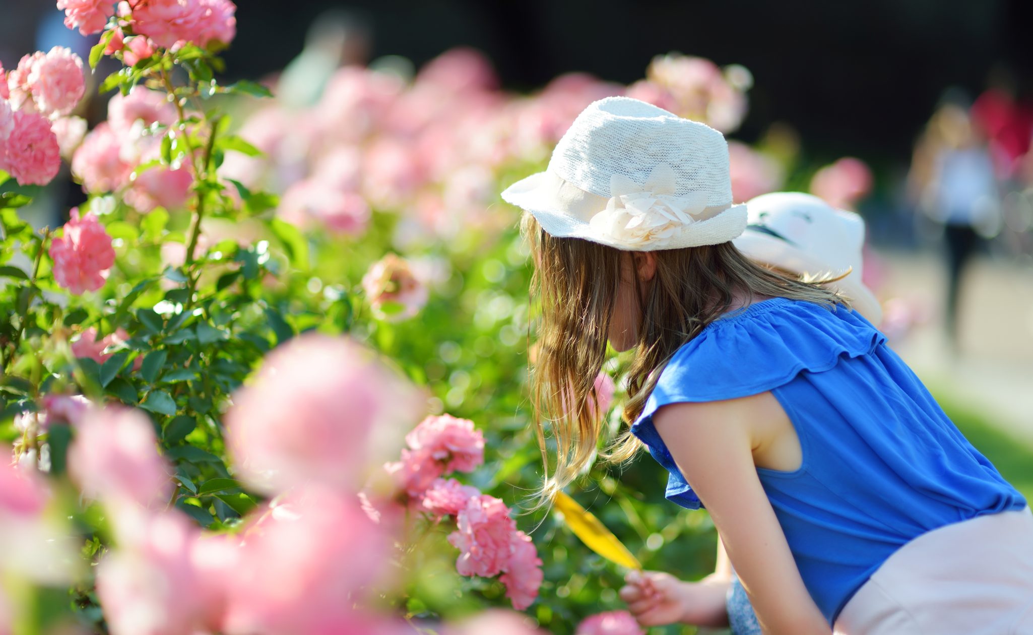 girl smelling flowers in tuscany in italy