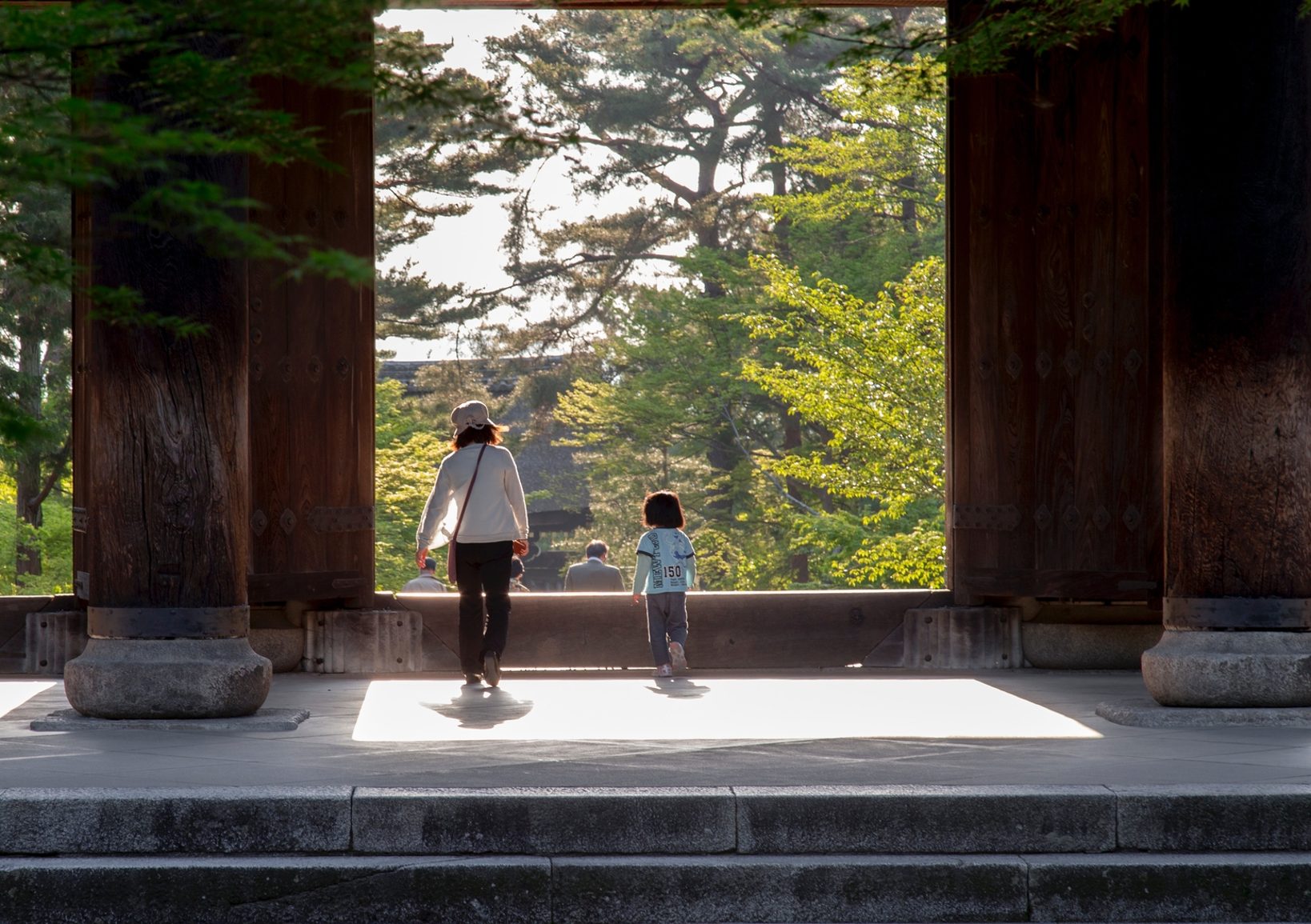 Mother and child walking through gate in Japan