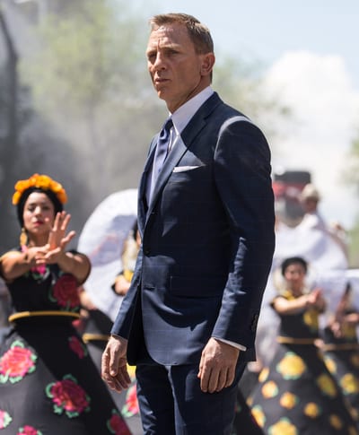 Bond (Daniel Craig) following Marco Sciarra through the Day of the Dead parade; Tolsa Square, Mexico City, Black Tomato