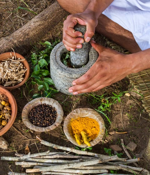 man preparing ayurveda medicine in uttarakhand in india