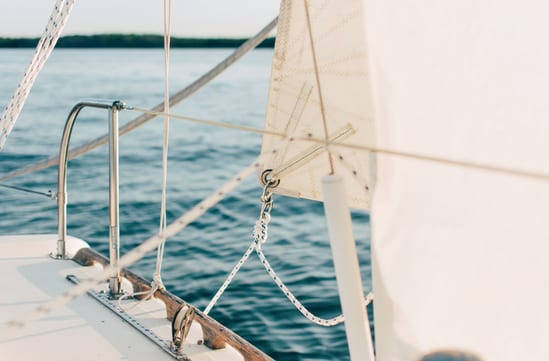 Sailing boat on blue water