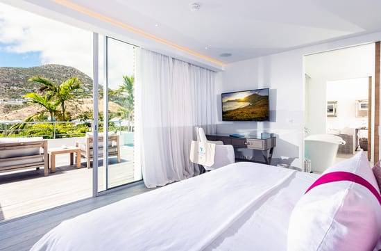 Vaulted ceilings, light wood floors, and the Atlantic through the glass