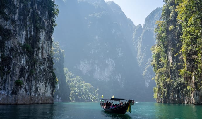 A boat travels through rocky outcrops in Thailand