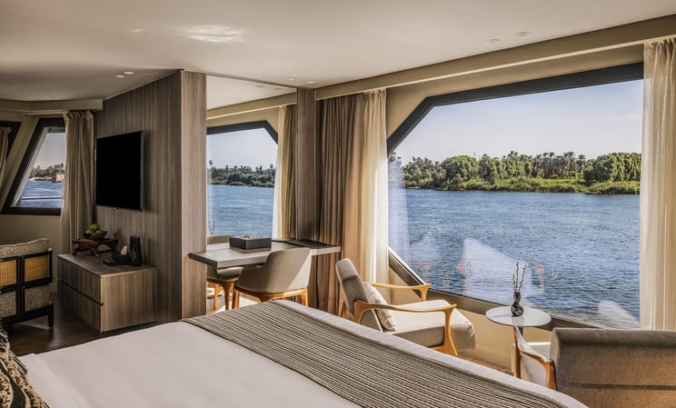 The Royal Suite opens directly to the Nile — floor-to-ceiling windows, nowhere else to look