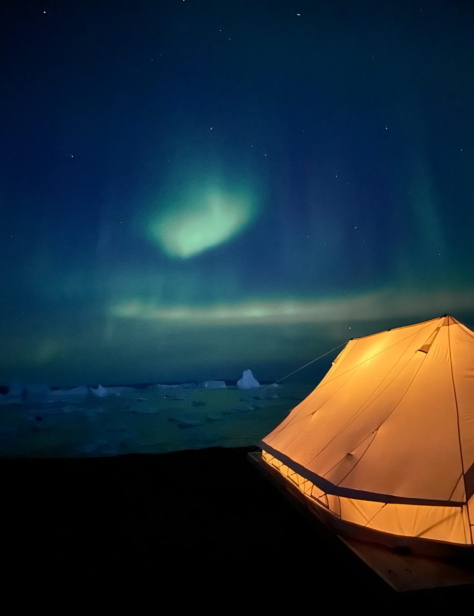 northern lights above a tent at camp saqqaq in disko bay in greenland