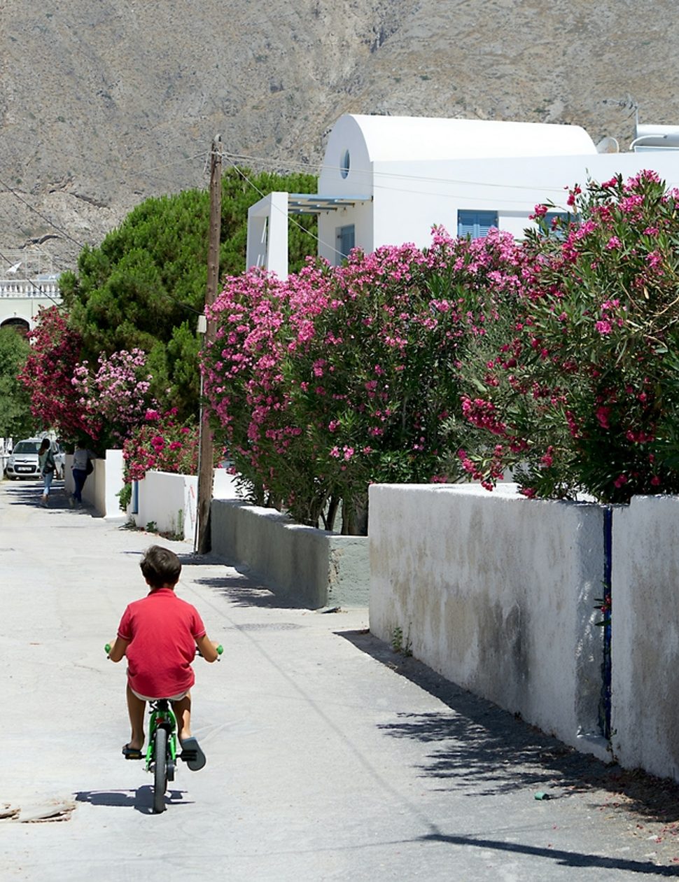 Kid cycling in Santorini