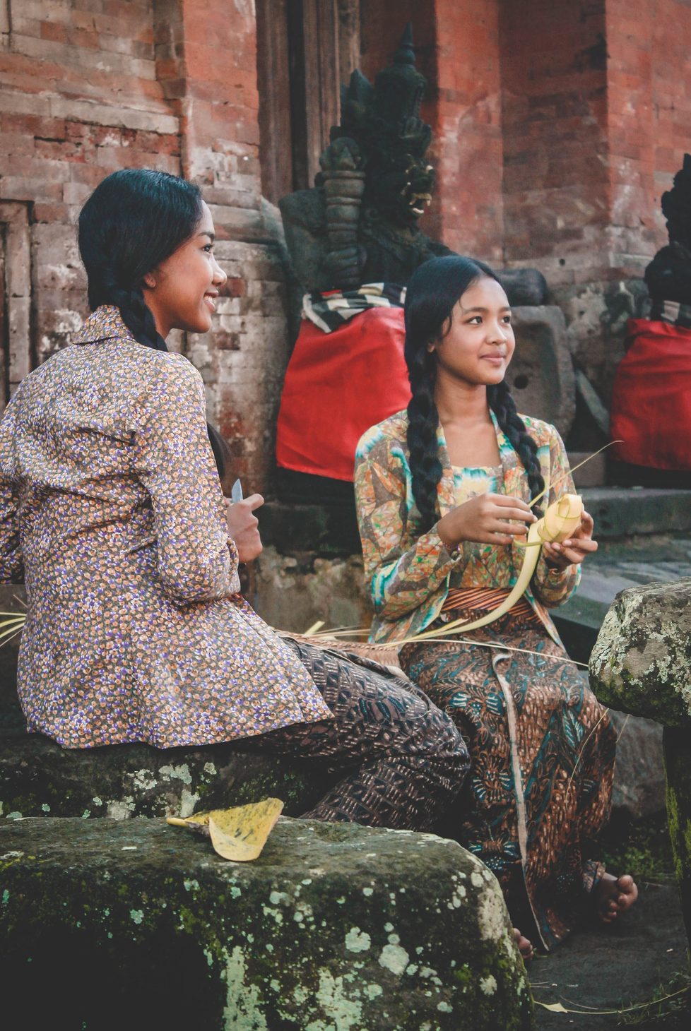 Two ladies weaving in Indonesia