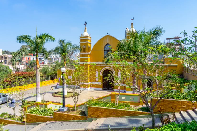Peru,,Lima,Barranco,,Beautiful,Yellow,Church,With,Palm,Trees,And