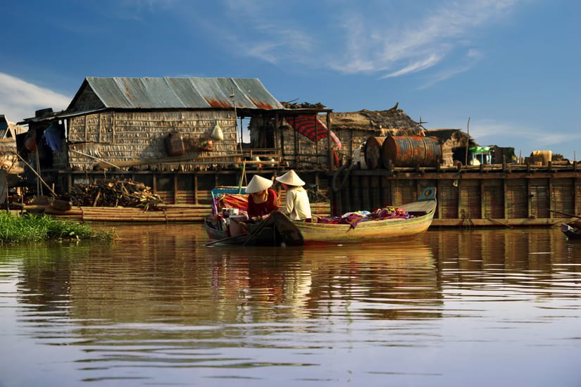 Cambodian women sail on a boat near the fishing village of Tonle Sap Lake in cambodia