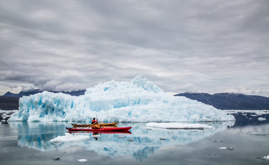 kayaking between icebergs at camp kiattua in greenland