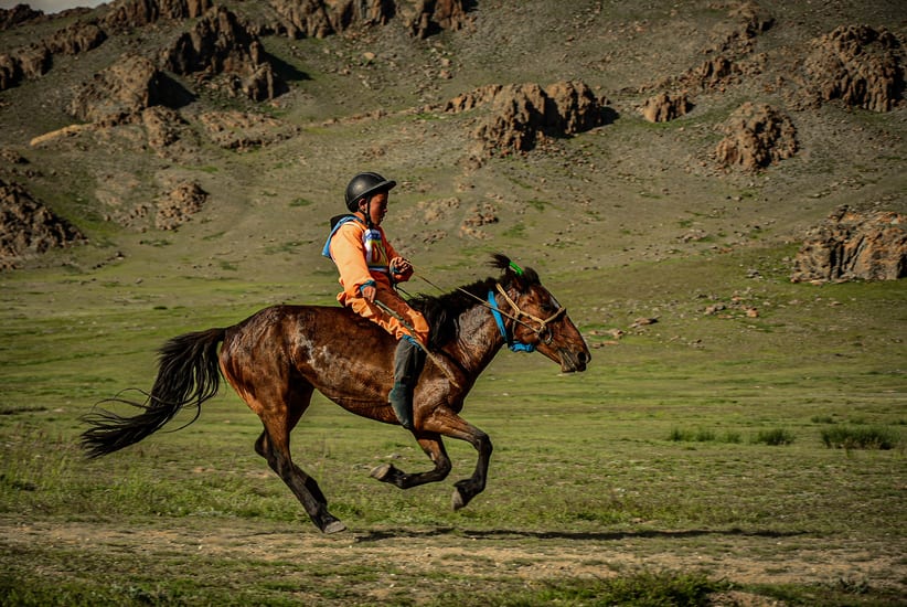 boy horseriding in naadam festival in mongolia