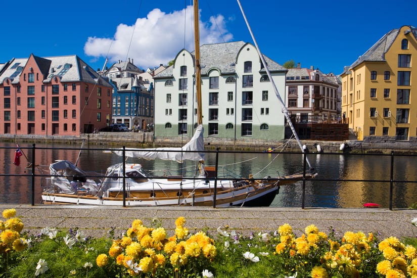 flowers by the river in alesund town in norway